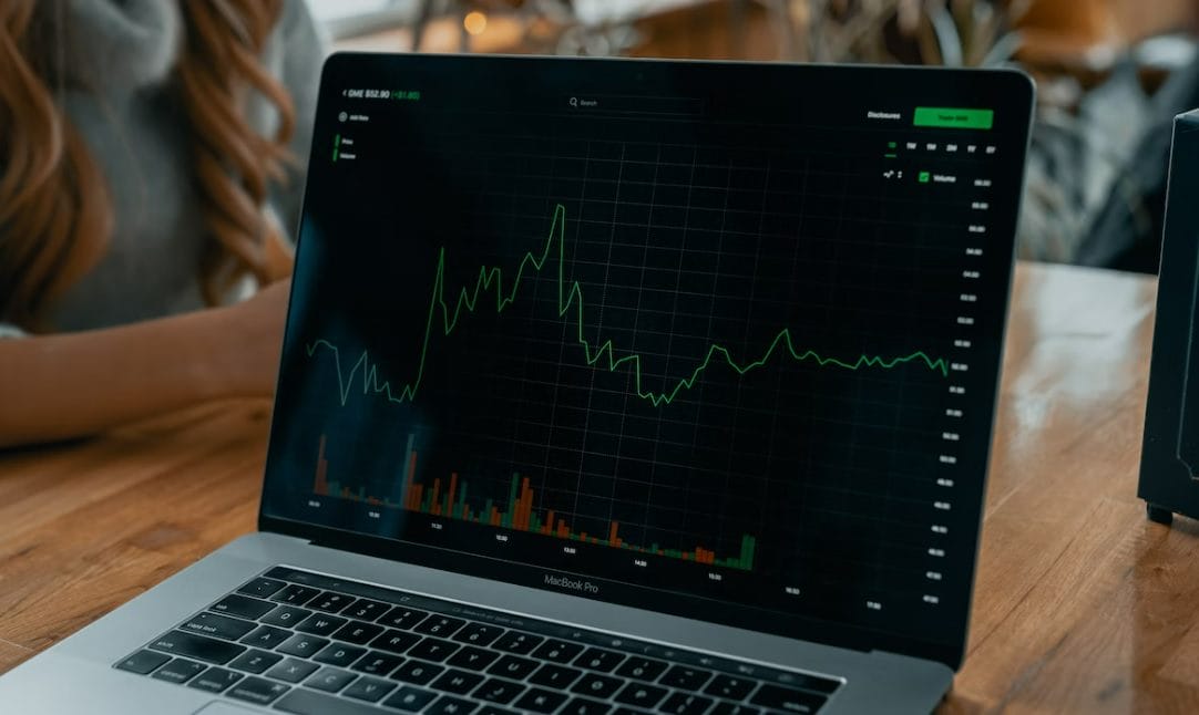 Understanding All Weather Portfolio cover photo laptop with stock graphs