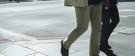 Two people walking in city