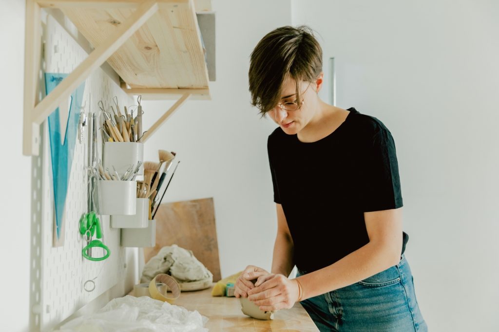 person working with clay