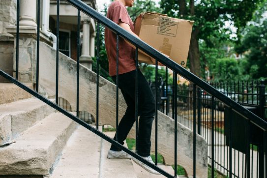 Man carrying a box down stairs