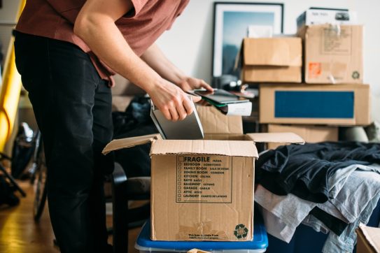 person packing up a box