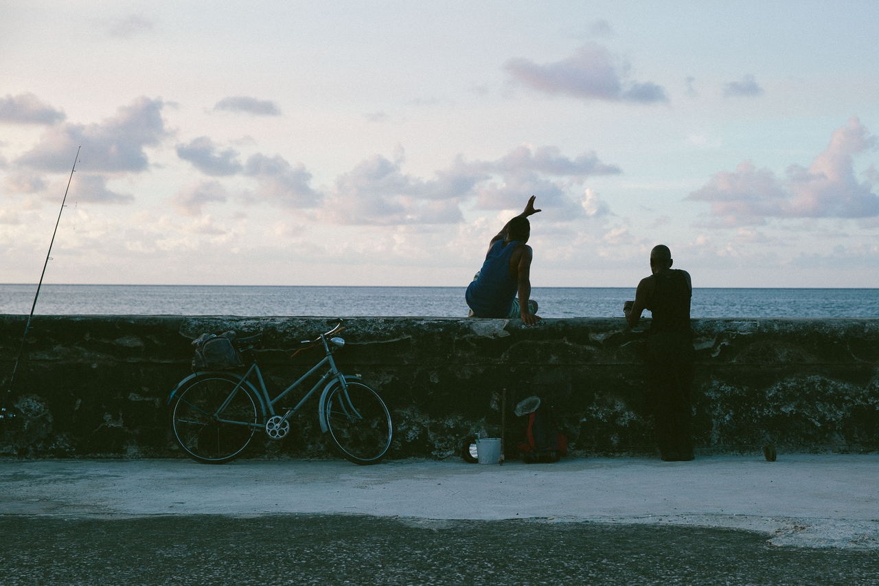 Two people on a beach wall