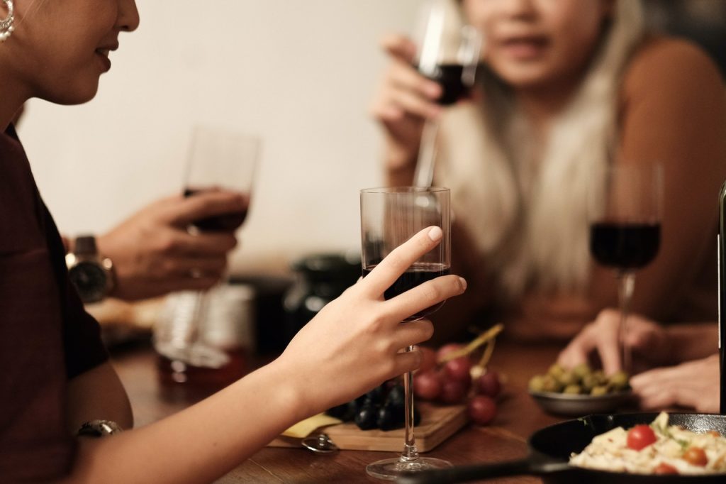 People talking and drinking wine