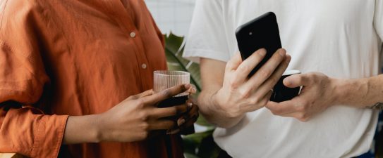 two people looking at a smartphone