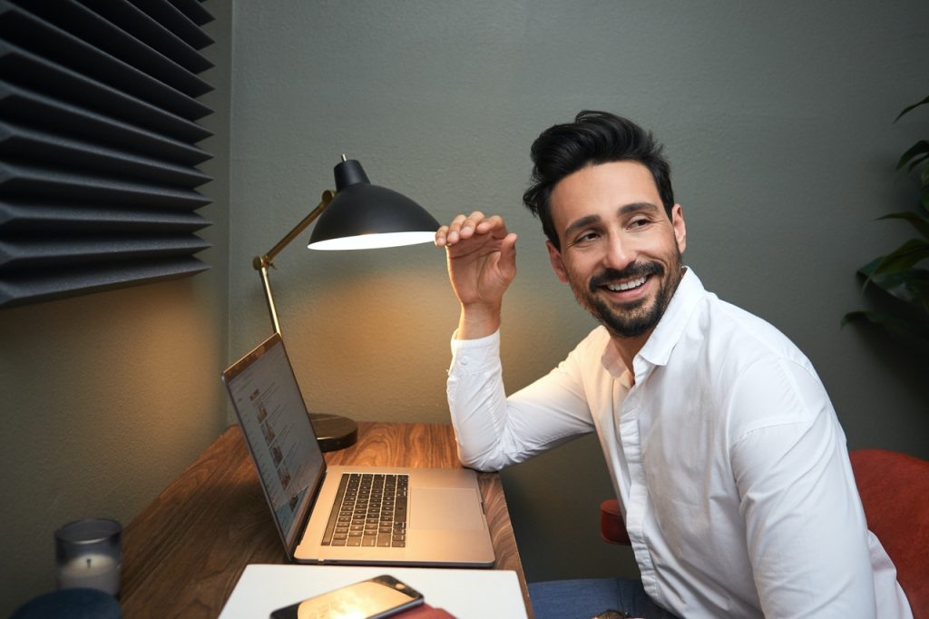 Man smiling at laptop