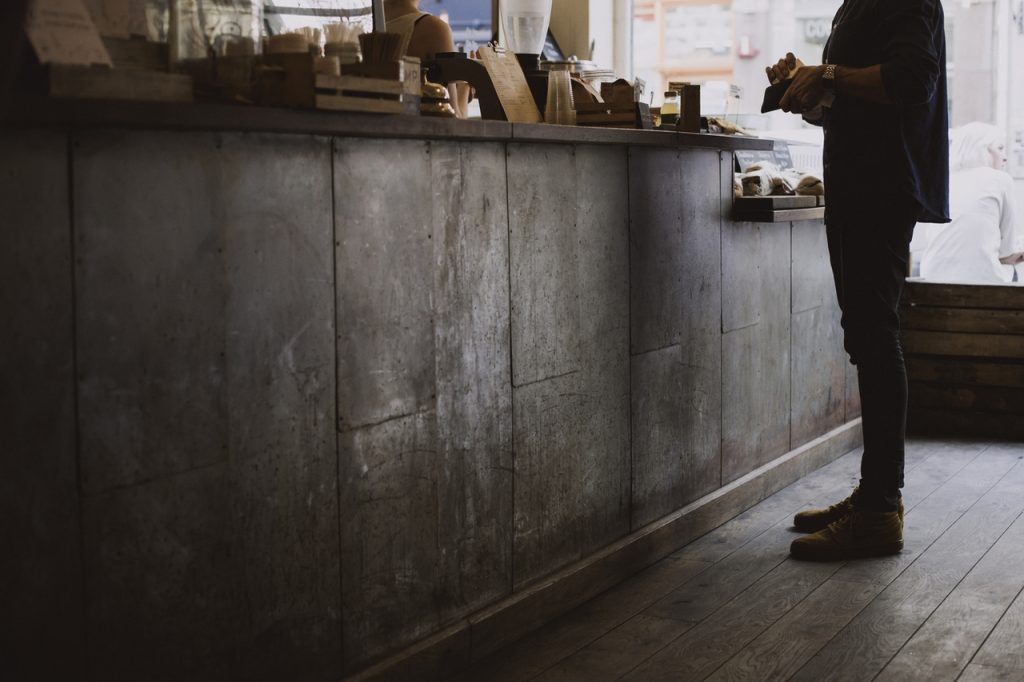 person paying at a cash register