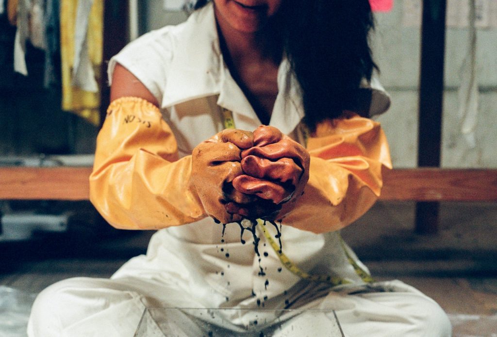 woman handling dye with gloves