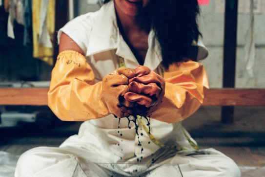 woman handling dye with gloves