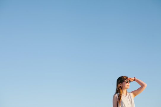 woman against a blue sky