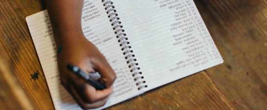 person writing a checklist