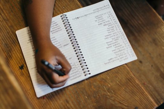 person writing a checklist