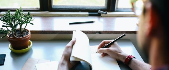person writing in a notebook