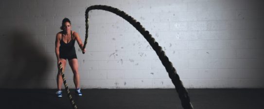 Girl using battle ropes