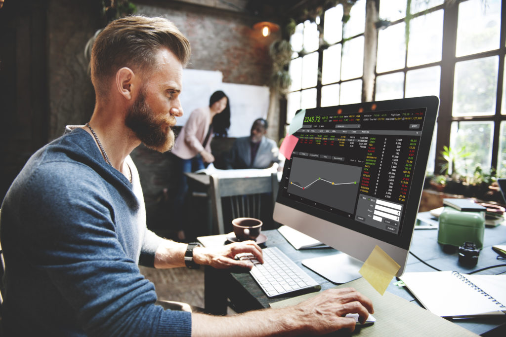 man looking at a graph on a computer