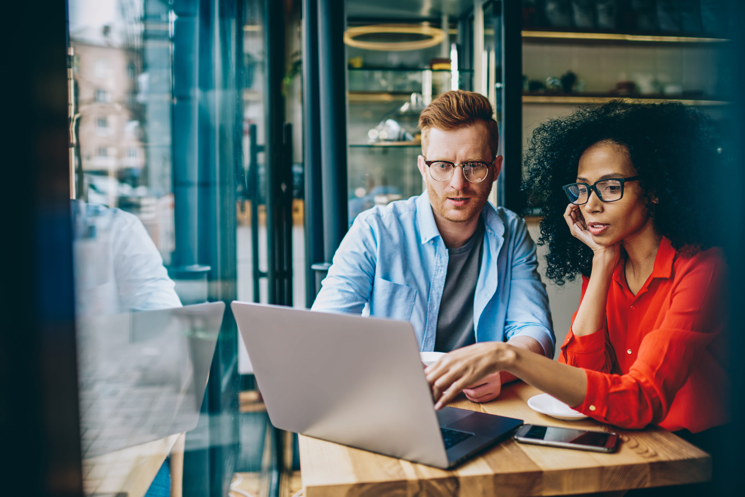 man and woman with lap top tracking progress towards goals 