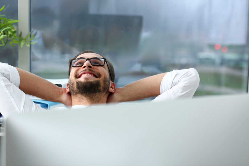 Man relaxing at his computer