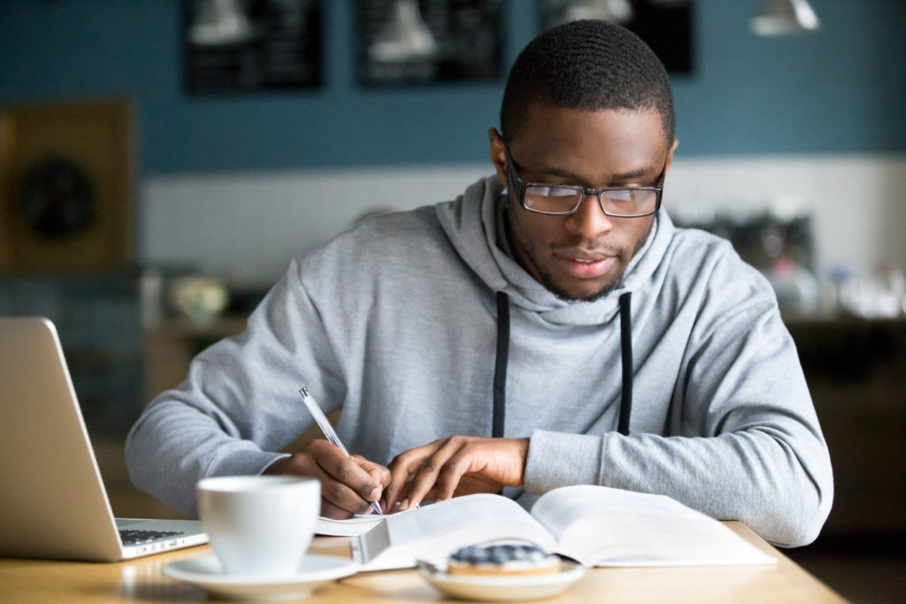 man writing notes