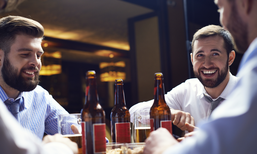friends sitting at a bar together drinking